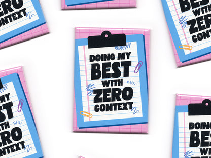 Multiple “Doing My Best With Zero Context” magnets scattered across a white background. The magnets feature a pink grid pattern, a blue clipboard illustration, and bold black text on lined paper.